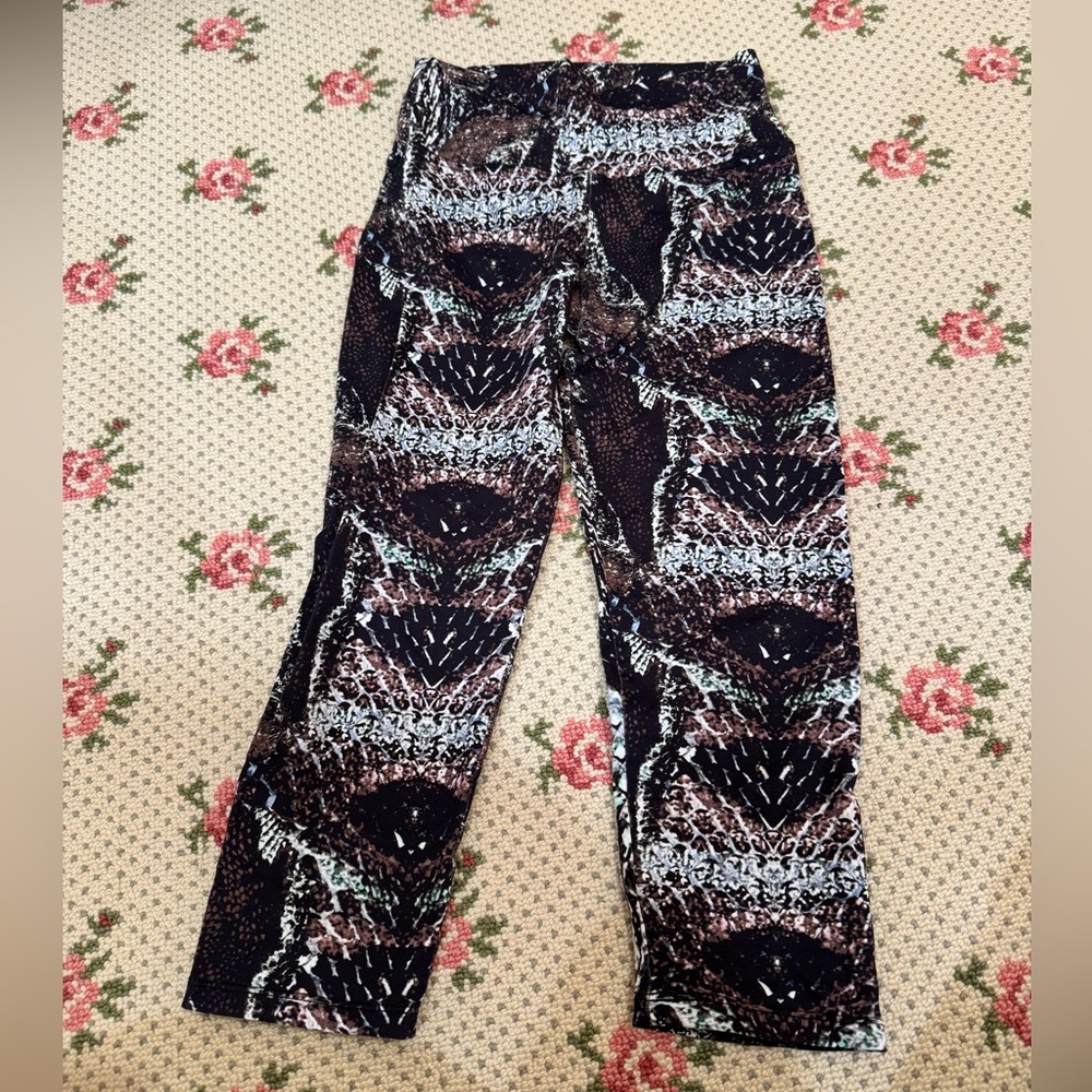 Bandier x Candida Maria activewear leggings with a multicolor reptile print